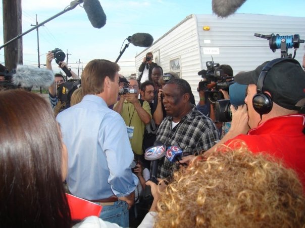 Photograph of New Orleans Senator John Edwards with ACORN leaders in New Orleans’ Lower 9th Ward, which was the first stop on his “Road to One America” tour.