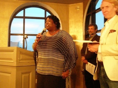 Photograph of ACORN organizer Tanya Harris-Glasow speaking at an event alongside Wade Rathke and TK (photo credit: Marie Hurt).