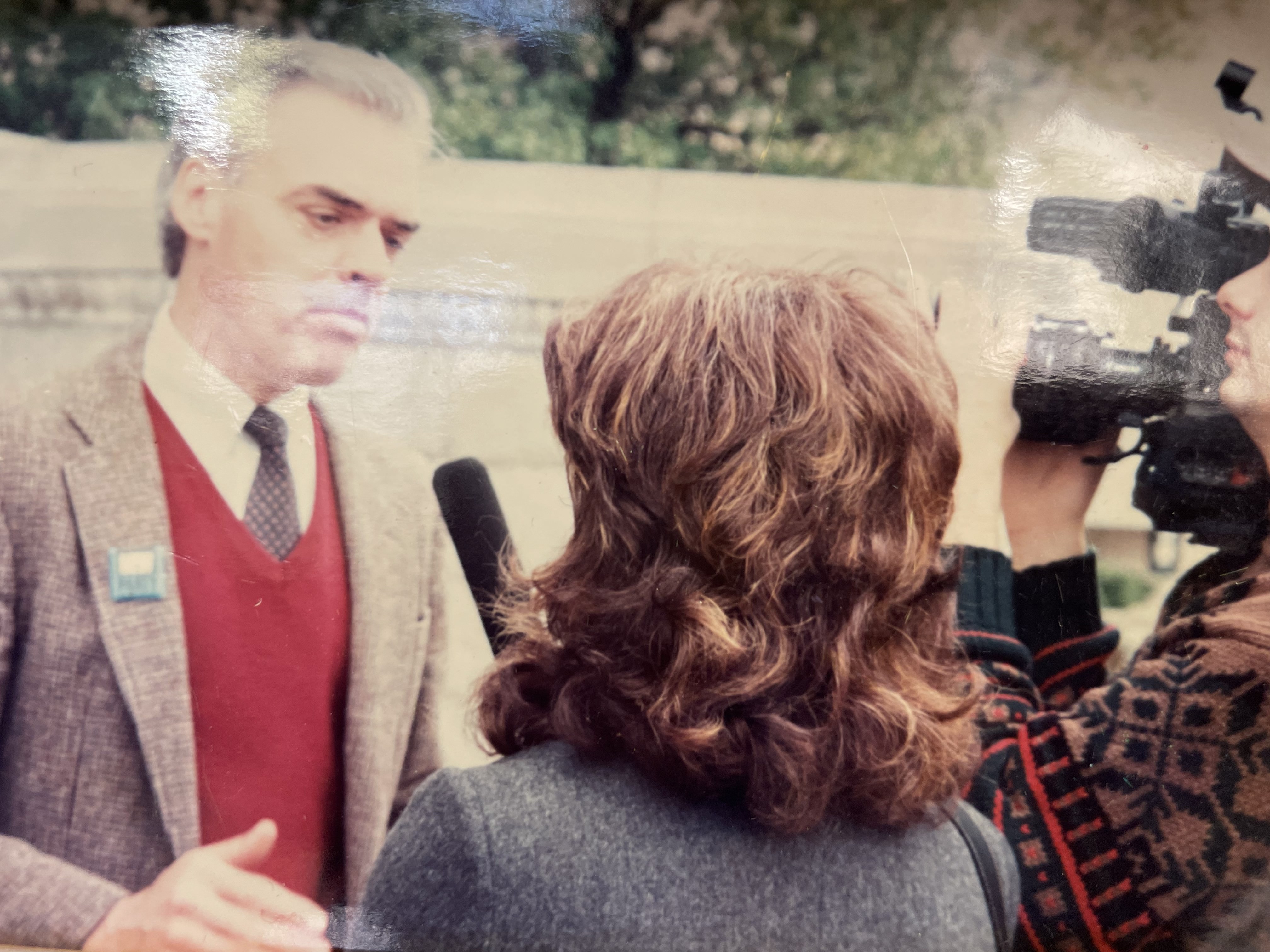 Photograph on the wall at the Arkansas Community Organizations (ACO) office in Little Rock, Arkansas of of Jim Lynch talking to a TV news reporter about The Little Rock New Party to publicize their election-day success.
