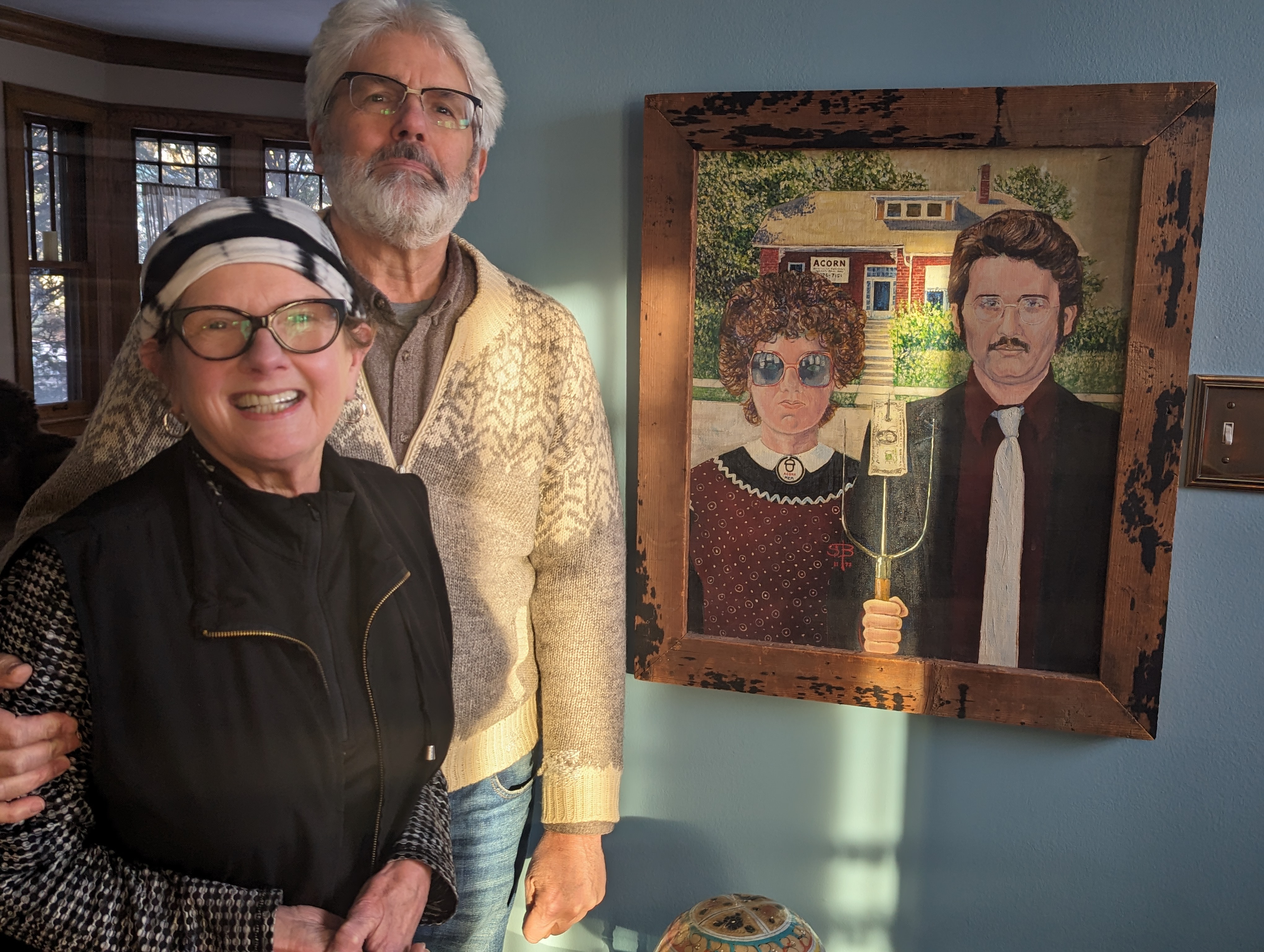 Former ACORN organizers Maureen McGoorty and Mike Shea standing next to Steve Bachmann’s “ACORN American Gothic” painting.
