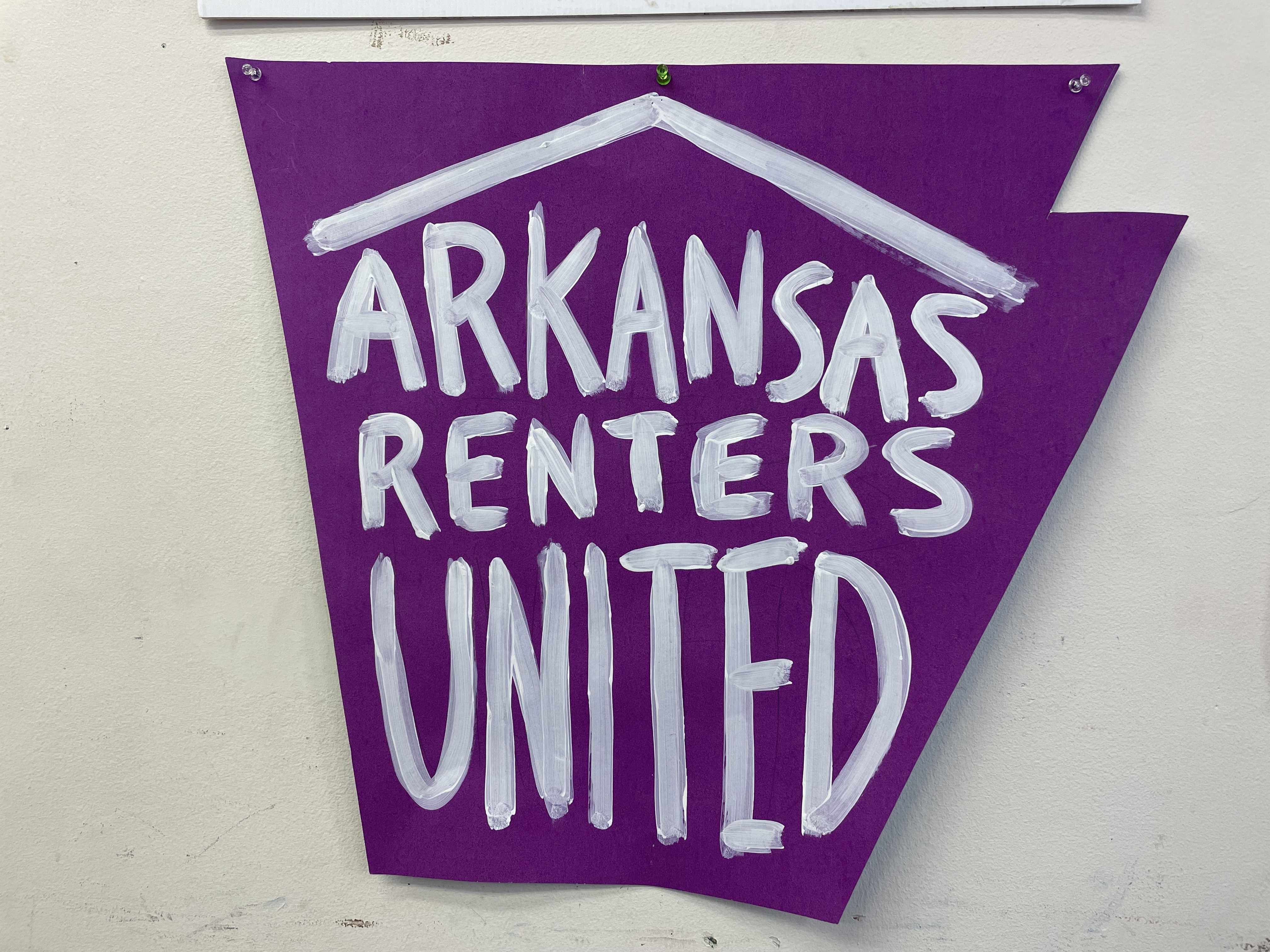 Poster hanging on the wall at the Arksansas Community Organizations (ACO) office in Little Rock, Arkansas that reads, “Arkansas Renters United”.